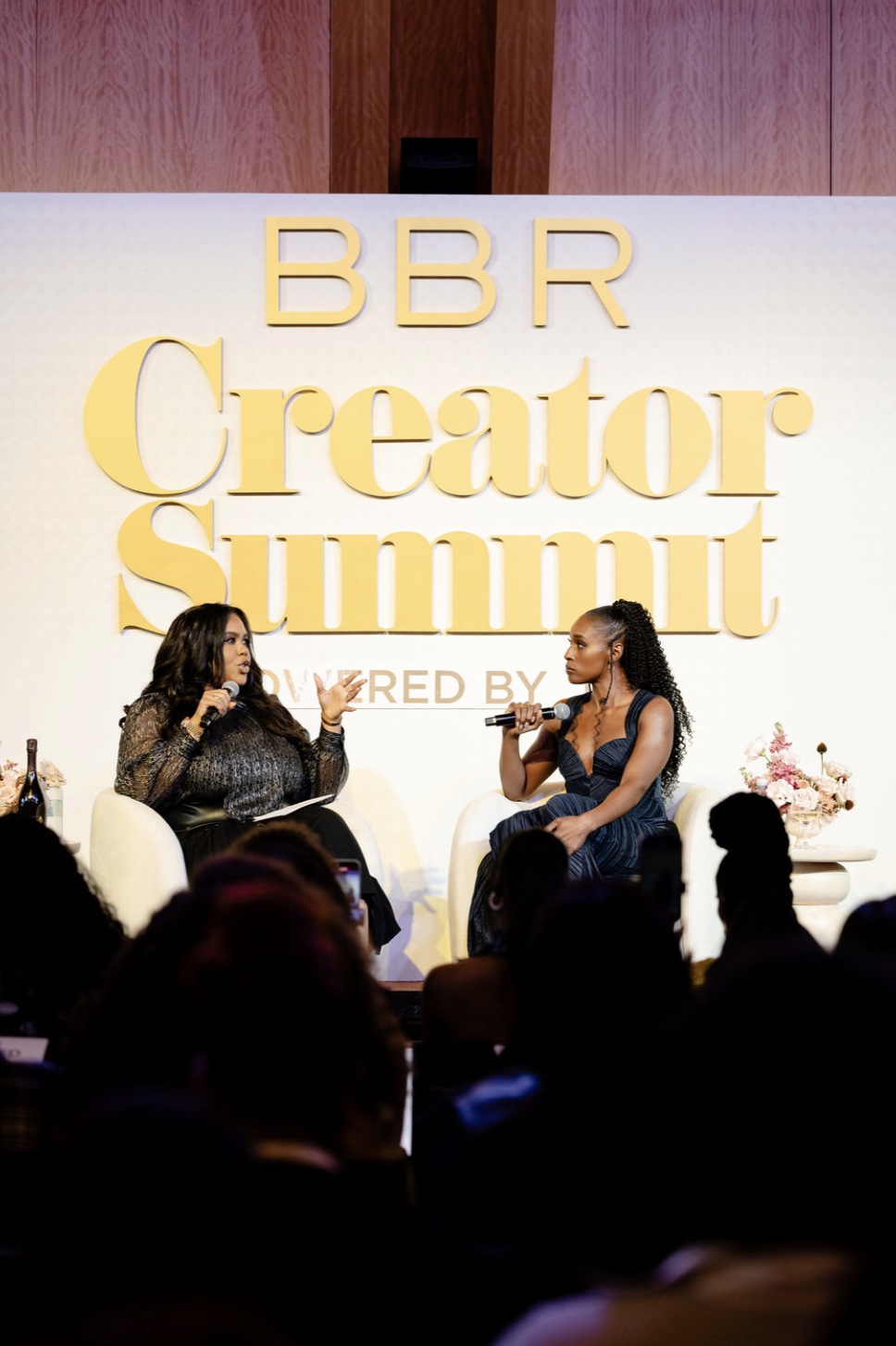 Two speakers on stage at the BBR Creator Summit